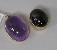 A 9ct gold and cabochon amethyst set pendant and a yellow metal and cabochon garnet set clasp?