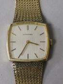 A gentleman's gold plated Longines manual wind dress wrist watch, on a gold plated bracelet.