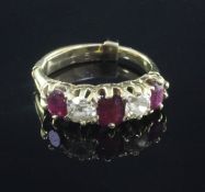 A gold and graduated five stone ruby and diamond set half hoop ring, set with oval, emerald and