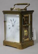 A Swiss gilt brass alarm carriage clock, retailed by Matthew Norman, London (three glass panels a.