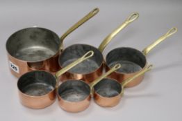 A set of 6 brass-handled copper graduated sauce pans Largest 12.5cm