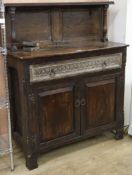 A 17th century style carved oak cupboard W.107cm