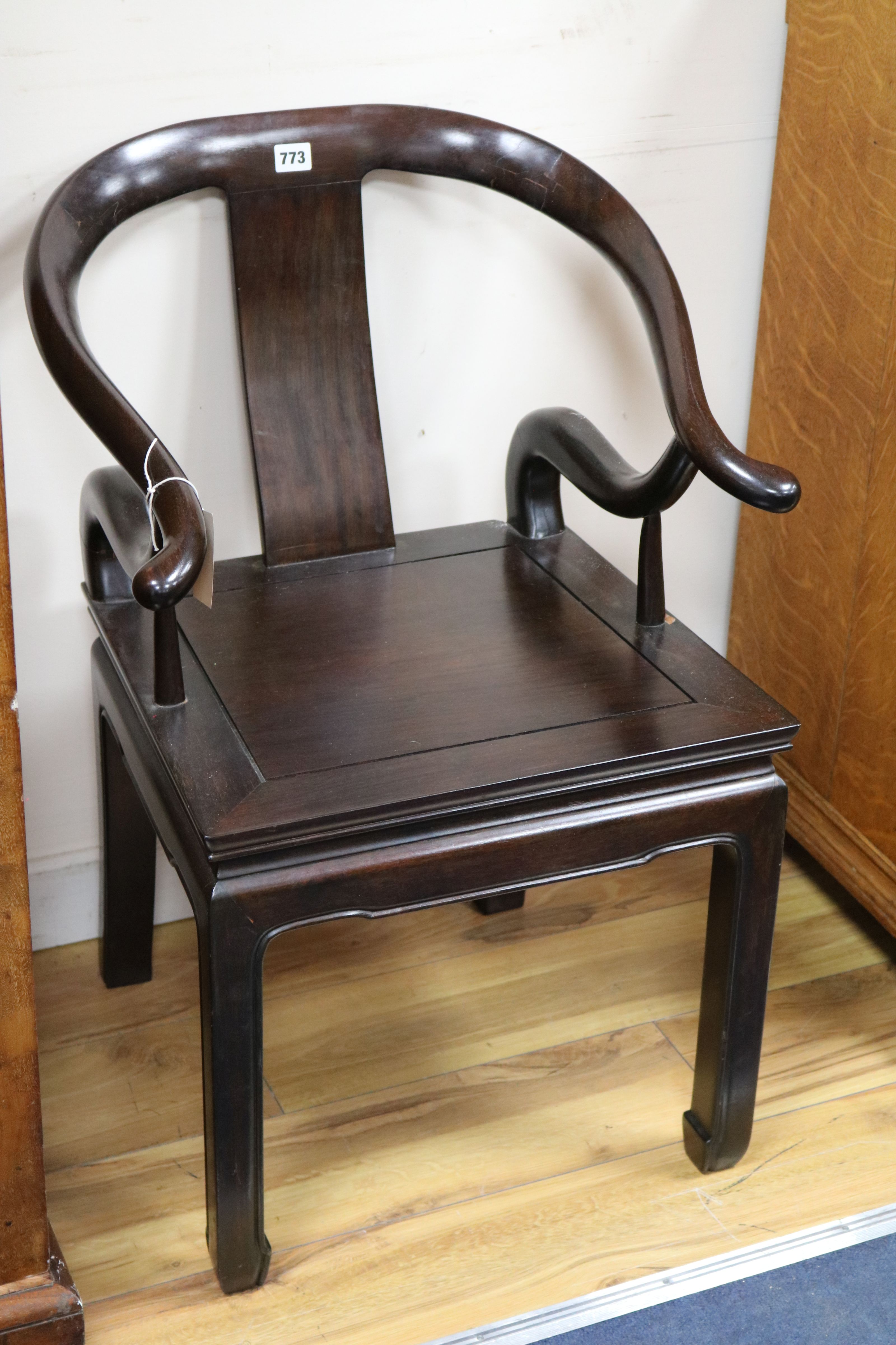 A Chinese hardwood open arm solid seat chair, with maker's label