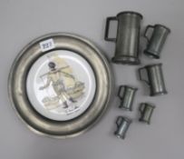 A set of 6 French pewter measures and a pewter plate Tallest 11cm