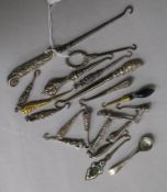 A collection of silver handled button hooks, a gold handled button hook and other items.