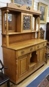 An Art Nouveau oak sideboard, the superstructure centred by a pierced copper fronted cupboard,.152cm