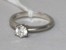 A modern platinum and solitaire diamond ring, the stone weighing approximately 0.50cts, size L.