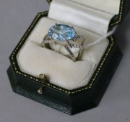 A modernistic white metal, aquamarine and diamond triple band dress ring, with marquise shaped