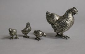 An Italian 800 standard white metal hen and three chicks.