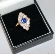 A yellow metal, sapphire and diamond cluster marquise shaped ring, size O.