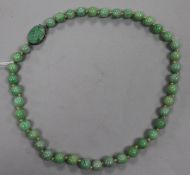 A single strand jadeite bead necklace, with carved jadeite clasp, 42cm.