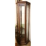 A stained beech framed hexagonal display cabinet, with four shelves W.73cm