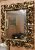 A gilt scroll frame wall mirror W.90cm