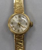 A ladys' 9ct gold Omega dress watch on textured bracelet