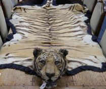 A tiger skin rug, complete with head and claws