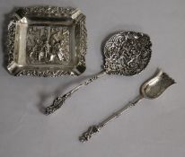 A 20th century Dutch white metal repousse ashtray, a Dutch white metal spoon and an early 20th