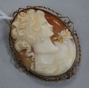 A large cameo brooch carved with the head of a maiden, in 9ct gold openwork mount
