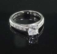 A modern platinum and single stone diamond ring with diamond set shank, with accompanying IGI