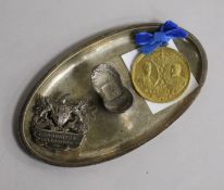 A Chinese white metal chop sticks stand and two ceremonial medallions.