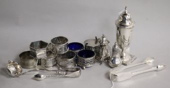 A collection of silver condiments, a sugar caster, napkin rings and sundries