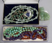 A collection of hardstone bead necklaces, including a pale green jade example with dragon clasp,