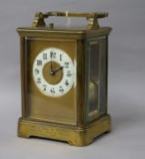 A French brass carriage clock, having hour-repeat movement with enamelled Arabic chapter ring,