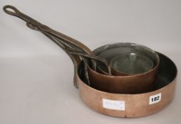 Four graduated 19th century copper saucepans