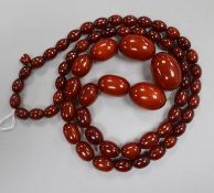 A single strand graduated simulated amber bead necklace, gross weight 80 grams, 84cm.