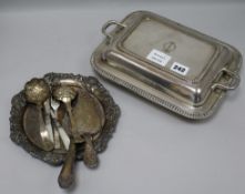 A plated entree dish with a two handled cover and sundry plated wares