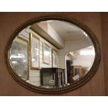 A gilt oval wall mirror W.79cm