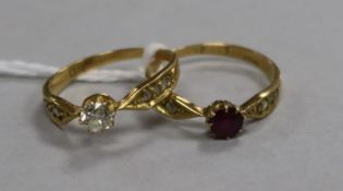 An 18ct gold and single stone diamond ring with diamond set shoulders and an en suite ruby and