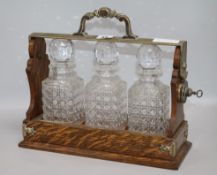 A three bottled tantalus height 31cm width 35cm