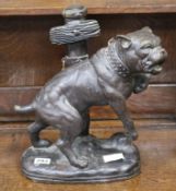A bronze model of a bulldog tied to a post width 33cm height 39cm