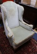 A wing armchair with pad feet