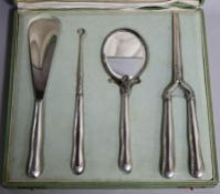 A cased early 20th century continental 800 standard white metal handled dressing set, comprising a