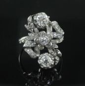 An 18ct white gold and diamond cluster upfinger ring, set with rose cut and three larger round cut