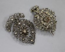 Two 19th century Indian white and yellow metal brooches, one set with rose cut diamonds, largest