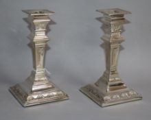 A pair of late Victorian repousse silver candlesticks, by Charles Stuart Harris, London, 1896,