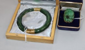 A modern jade and yellow metal-mounted bangle (unmarked) and a similar tablet ring, mounted with a