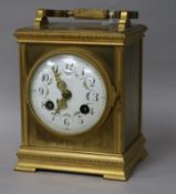 A French gilt brass carriage clock, striking on gong and having circular enamelled Arabic dial
