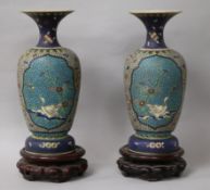 A pair of Japanese ceramic cloisonne vases, on stands height 22cm