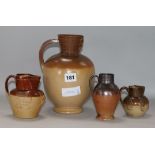 A GI stoneware jug, a Doulton jug and two others 8cm - 22cm