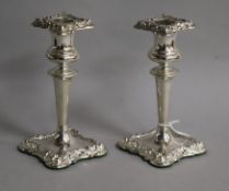 A pair of Edwardian repousse silver candlesticks, I.S. Greenberg & Co, Birmingham, 1905, 13.2cm,
