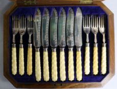 A set of twelve pairs of Victorian ivory handled silver fish eaters by Joseph Rodgers & Sons,
