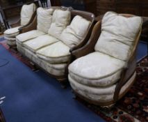 A 1930's three piece parcel gilt walnut double caned bergere suite settee W.190cm