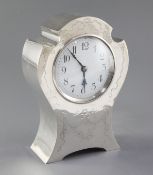 An Edwardian silver mounted shaped balloon cased mantel clock by William Comyns, with engraved