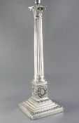 A 20th century silver plated corinthian column table lamp, the pedestal decorated with laurel