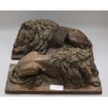 A pair of oak carvings of lions height 15cm width 37cm