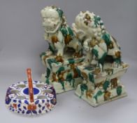 A pair Chinese terracotta sancai-glazed lion dogs, each modelled seated on a plinth (some faults,