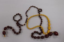 A graduated simulated cherry amber bead necklace, approx 76g and another amber style necklace.